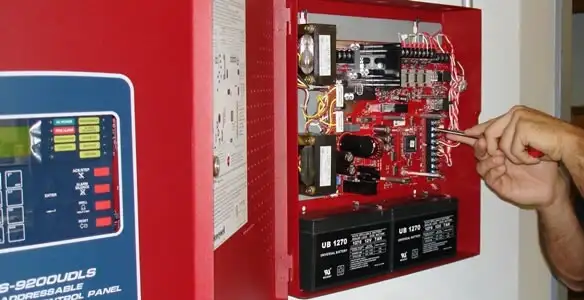fire alarm installation service showing technician configuring fire alarm control panel in Cherry Hill, NJ