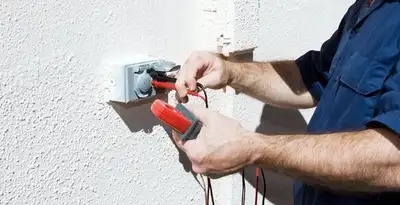 Electrician performing home electrical outlet and wiring inspection in Cherry Hill, NJ