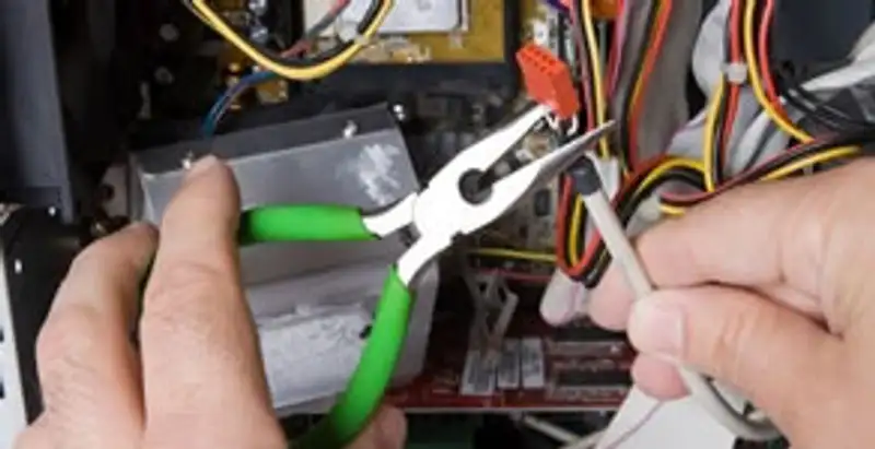 Licensed electrical contractor performing electrical repair with tools in Haddon Heights, NJ