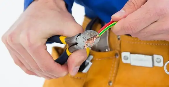 licensed electrician securing electrical wiring with professional tools during service work in Cherry Hill, NJ