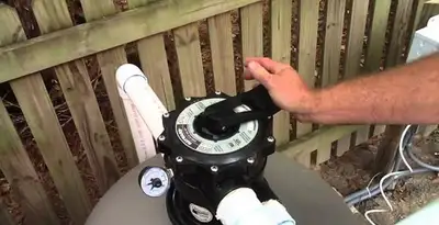 pool pumps service showing professional adjustment of pool pump control system in Cherry Hill, NJ